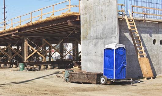 portable restrooms lined up for construction workers to use